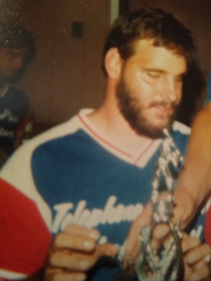 Photo of Mike Berwald receiving a trophy at a Pioneers Event in 1982